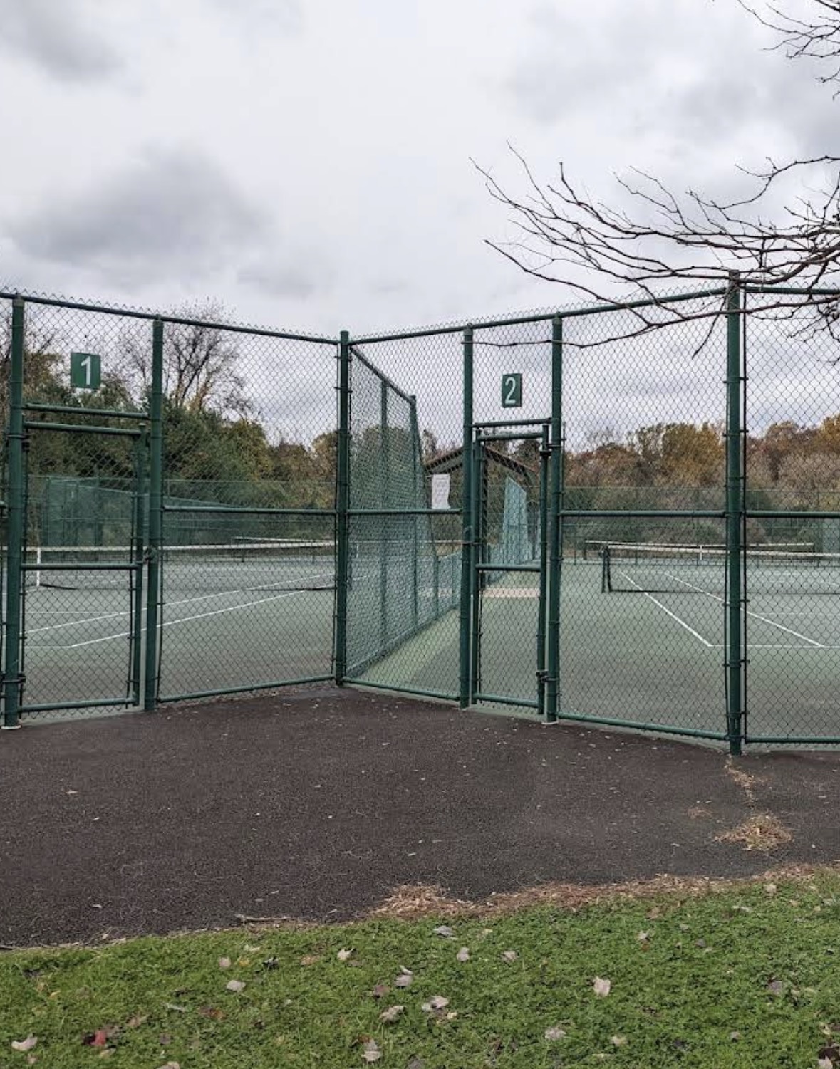 Gated entrance to the fenced tennis courts at Frosty Hollow Tennis Center, Levittown